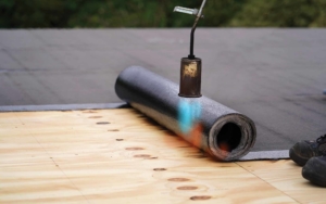 material coating being heated onto a roof