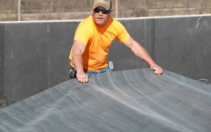 man installing an EPDM flat roof