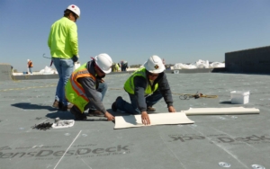 men at work on a roof